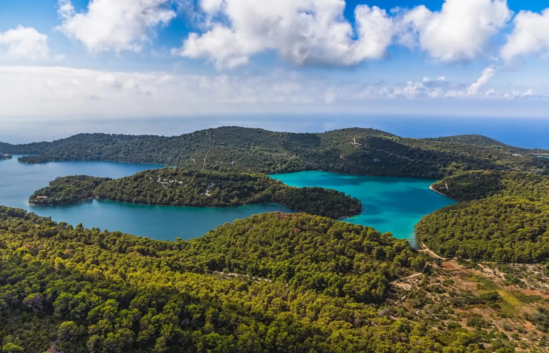Aerial view of lush green islands surrounding turquoise lakes leading to the Mediterranean Sea, Mljet.