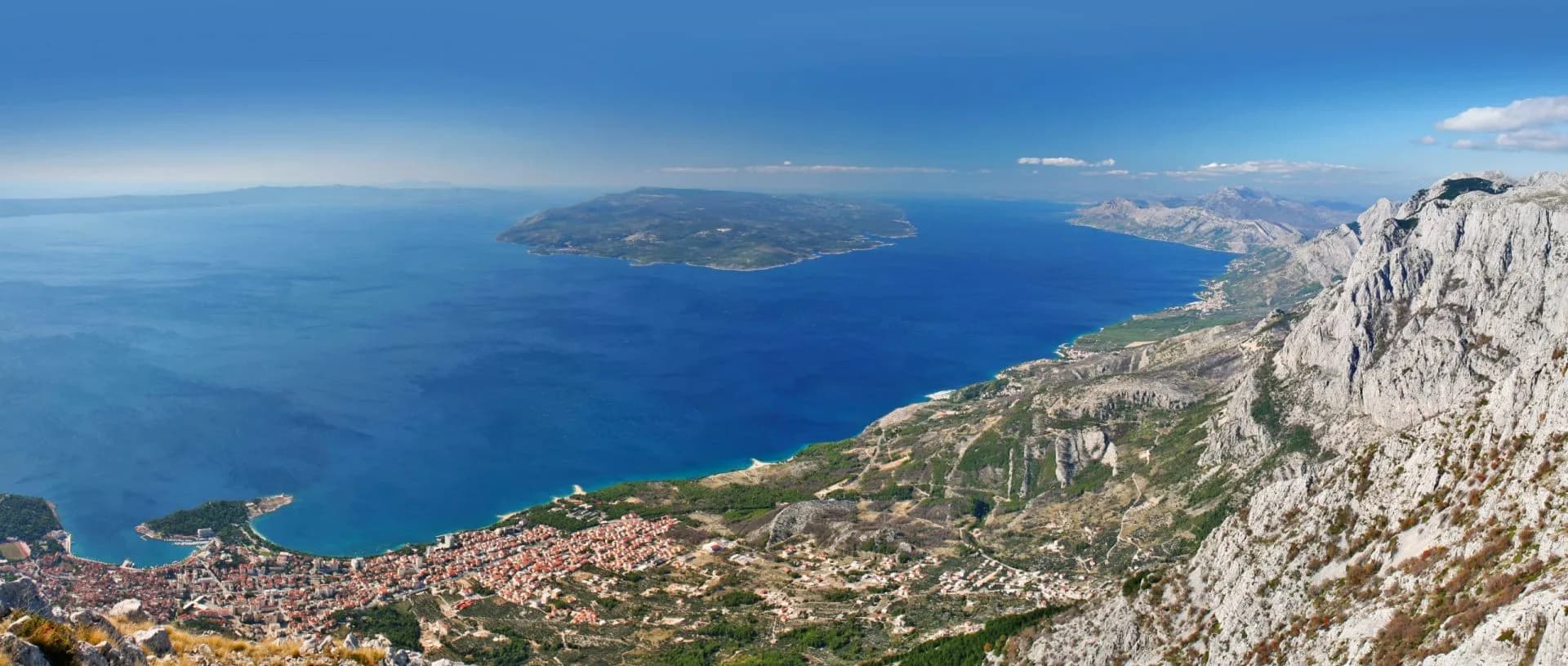 View from Biokovo mountain range over Adriatic Sea, coastline, and island.