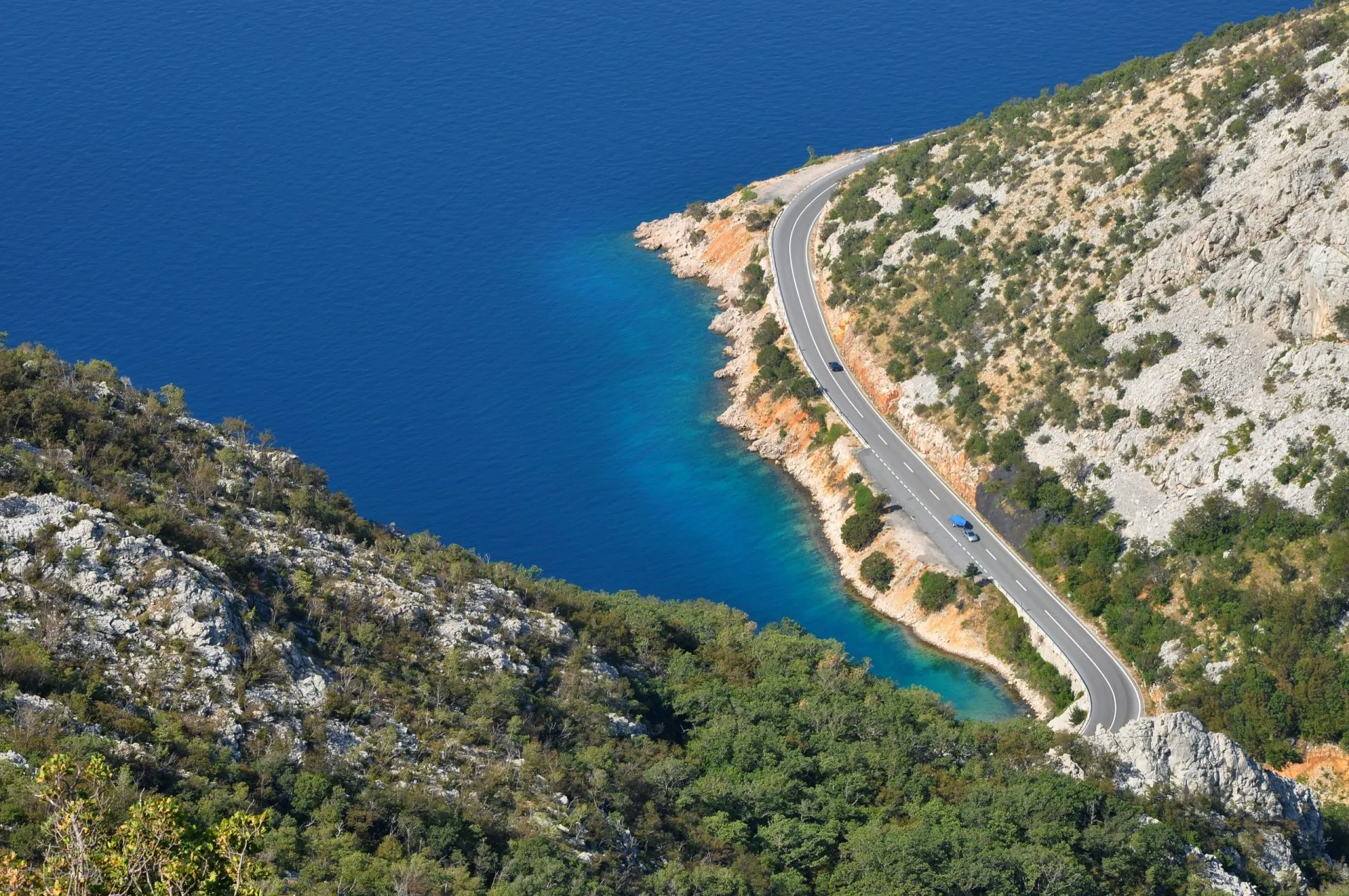 Aerial view of a winding coastal road and sea